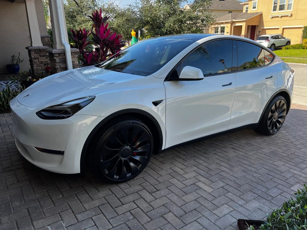 White Tesla Model Y with tinted windows