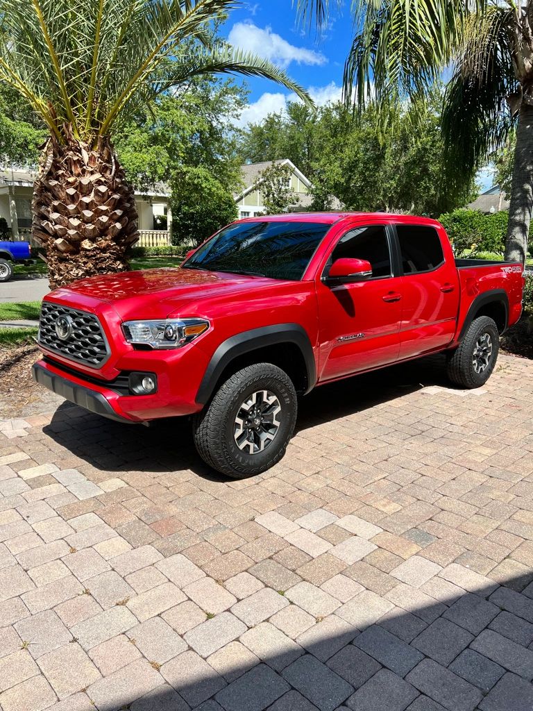 Red Toyota Tacoma with tinted windows