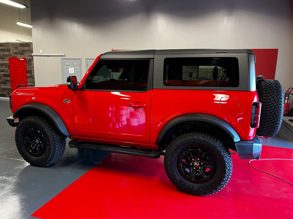 Red Ford Bronco with tinted windows